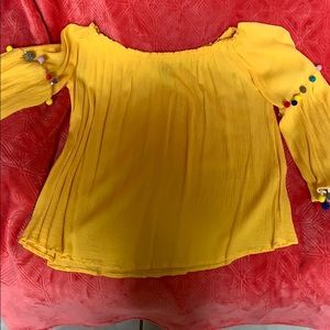 Off the shoulders bright yellow top with poms